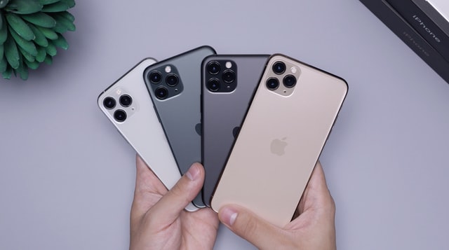 person showing different models in different colors of iphones